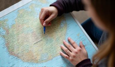 Travel planner working on a map